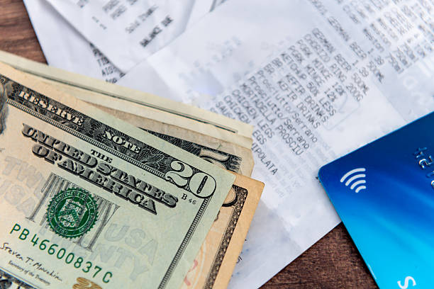 istock US dollars, grocery receipt and bank card. 2230954994