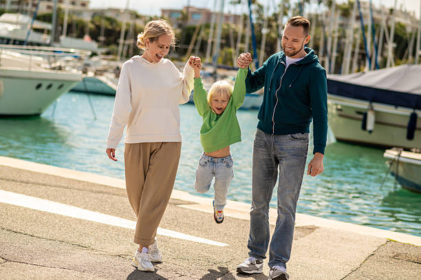 istock Three people walking on marina pier together 2230955960