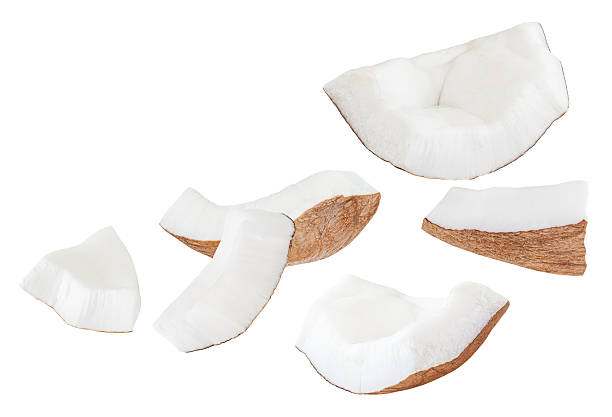 istock Isolated Coconut pieces falling on white background. Coconut explosion with broken pieces. Levitating coco nutslices  Top view. Flat lay. Pattern  2230956654