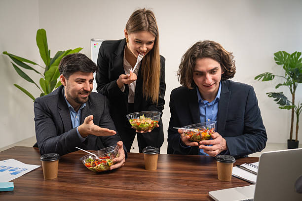 istock Colleagues Enjoying Healthy Lunch Break Together at Work 2230957020
