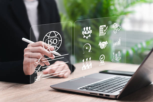 istock ISO document approved concept, Businesswoman Reviewing ISO Standard Documents for Industrial Quality Control, International Certification Audit, Fast Performance, Global Recognition, Product Quality 2230958008