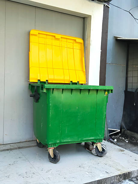 istock A Large Green and Yellow Garbage Bin with Wheels 2230958480