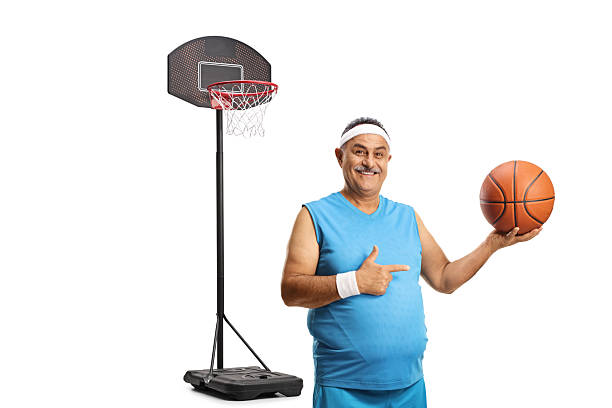 istock Happy mature man pointing at a basketball 2230958984