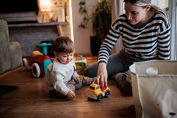 istock Smiling Mom Playing with Baby Boy 2230959493