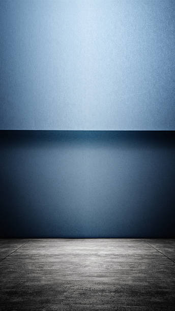istock Interior of a modern and minimalist studio with a blue wall and dark floor background. Mockup or copy space 2230959909