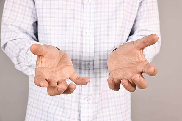 istock Man holding something on grey background, closeup 2230960262