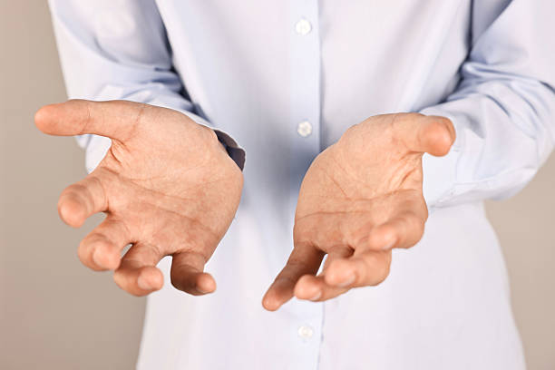 istock Man holding something on grey background, closeup 2230960283