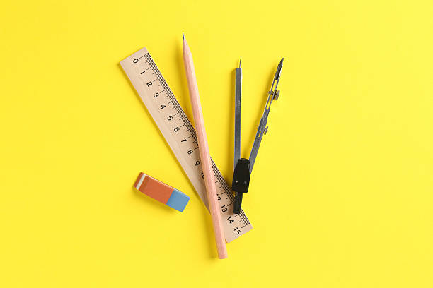 istock Ruler, pencil, eraser and compass on yellow background, flat lay 2230961759