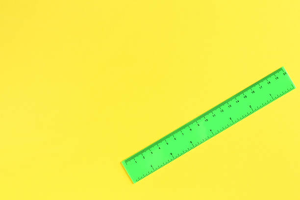 istock One green ruler on yellow background, top view. Space for text 2230961805