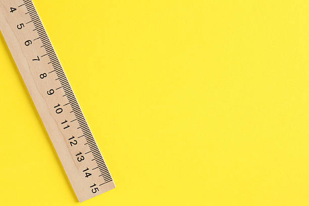 istock One wooden ruler on yellow background, top view. Space for text 2230961813