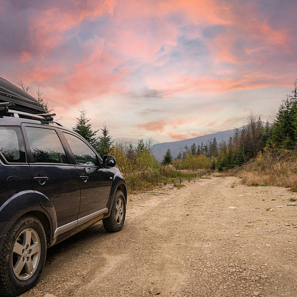 A sturdy off-road vehicle parked near a serene river in Western Australia, surrounded by striking natural landscapes. Perfect for travelers seeking adventure in the great outdoors.