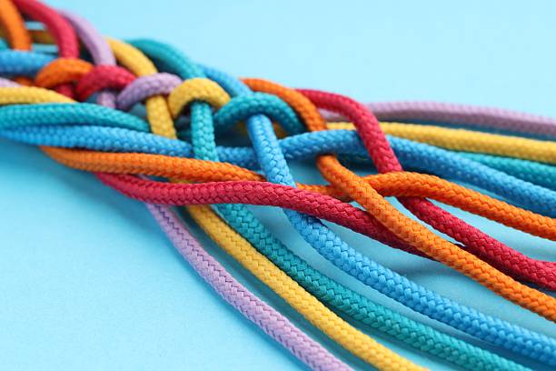 istock Colorful ropes tied together on light blue background, closeup. Unity concept 2230962095