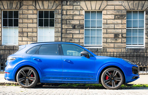 Edinburgh, Scotland - Side view of a blue Porsche Cayenne GTS Coupe, parked in Edinburgh's New Town.