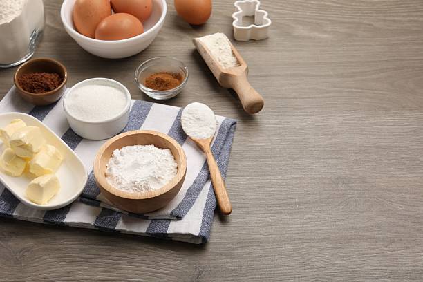 istock Baking powder in bowl and other products on wooden table. Space for text 2230965304