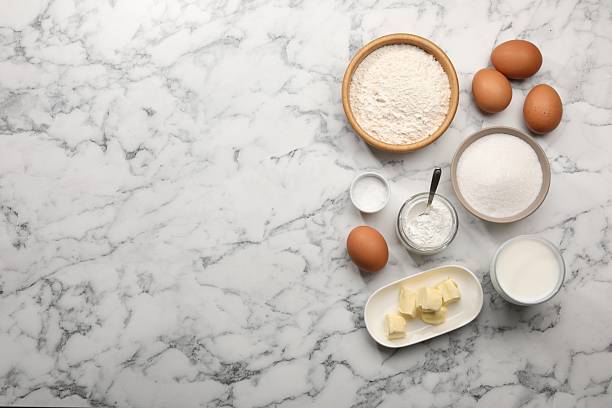 istock Baking powder and other products on white marble table, flat lay. Space for text 2230965339