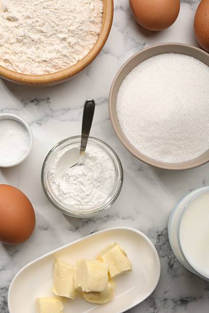 istock Baking powder and other products on white marble table, flat lay 2230965369