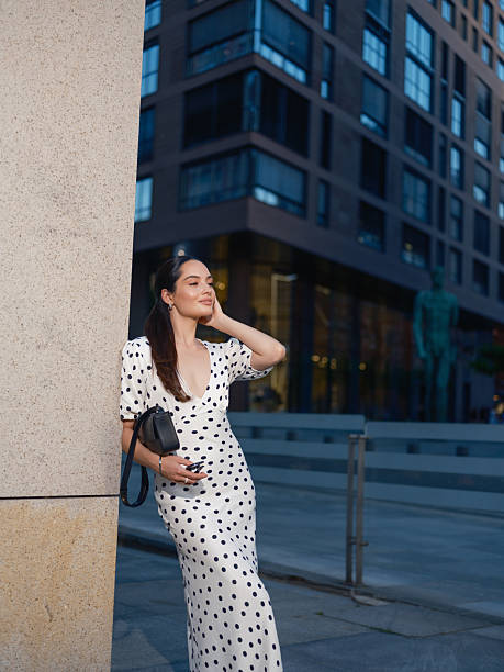 istock Stylish Woman Leaning on Pillar in urban setting 2230966935