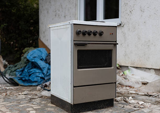 istock Old used gray stove next to a trash pile. Electronic waste. old kitchen appliance. Destroying the environment. Unnecessary waste 2230967576