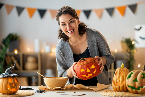 istock woman is carving pumpkin 2230968068