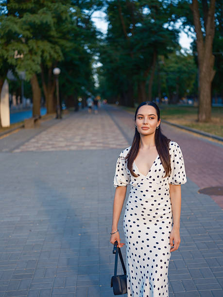 istock Stylish Woman Walking in Park 2230969365