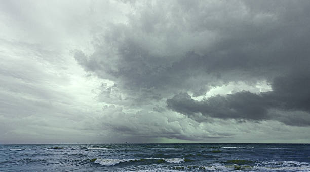 istock Dark storm clouds gathering over wild ocean waves 2230970145