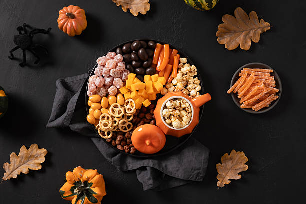 istock Halloween charcuterie board with pumpkin, chocolate candy, spider, crackers. 2230972475