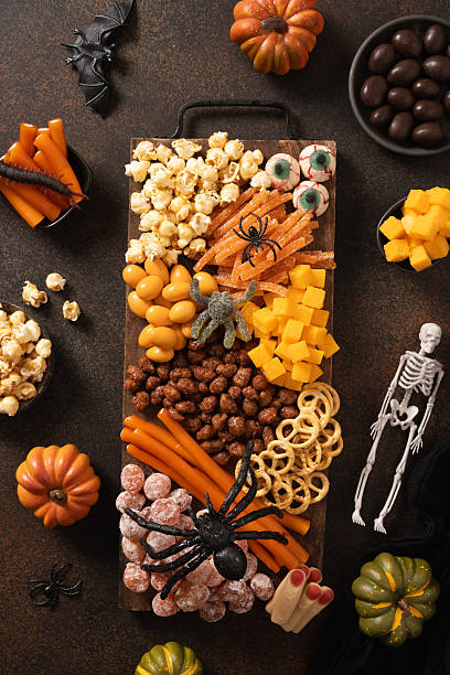 istock Halloween charcuterie board with pumpkin, chocolate candy, spider, crackers. 2230972477