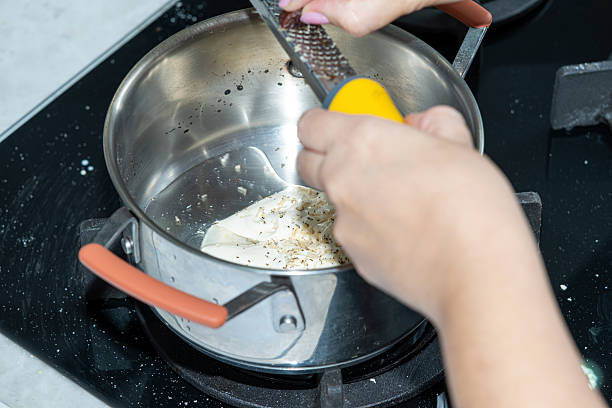 istock Cumaru being scraped over the pan. 2230973181