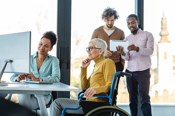 istock The image includes a person using a wheelchair, depicting inclusivity and teamwork in modern office 2230973313