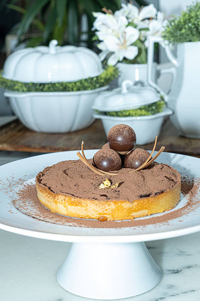 istock Chocolate pie covered with cocoa powder circular truffles and caramel chocolate_side view_vertical. 2230973915