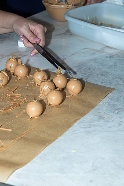 istock Truffles with caramel chocolate coating on parchment paper_vertical. 2230974384