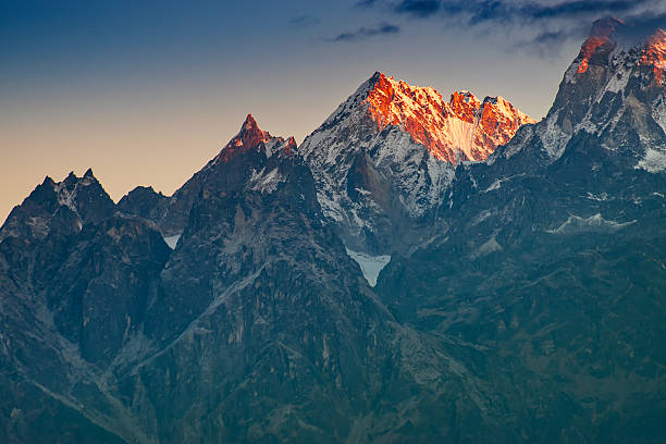 Beautiful first light from sunrise on Mount Kanchenjugha, Himalayan mountain range, Sikkim, India. Orange tint on the mountains at dawn