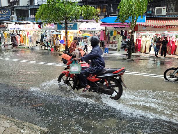 Ho Chi Minh, Vietnam - August 20, 2019: Appearance from Ho Chi Minh / Saigon Traffic jam day time. Raining Cats and Dogs at Ho Chi Minh / Saigon Traffic, Vietnam with vehicles, motorcycles, buses, peoples and Fog. Traffic jam,rush hour, rain day.