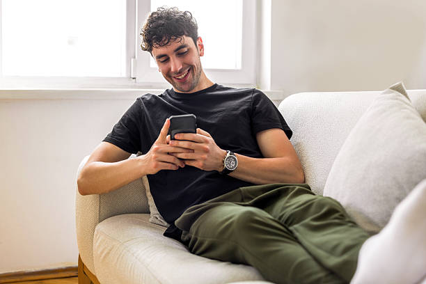istock Young and happy male using his smart phone 2230979009