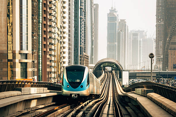 istock Modern Metro Train Traversing Skyscraper-Adorned Dubai Urban Landscape in Daylight 2230979402