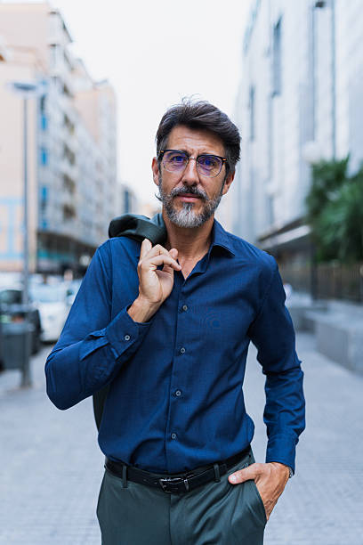 istock Confident businessman walking with jacket over shoulder 2230979408