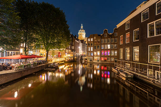 istock Amsterdam by night in the Netherlands with canals, lights, reflections in the water 2230980241