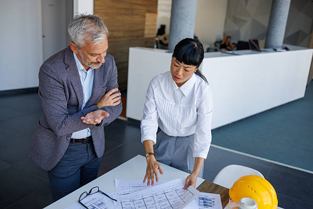 istock Architects examining blueprints of a new housing project 2230981036
