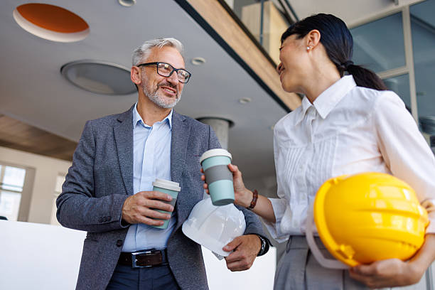 istock Architects having coffee break during meeting in office lobby 2230981232