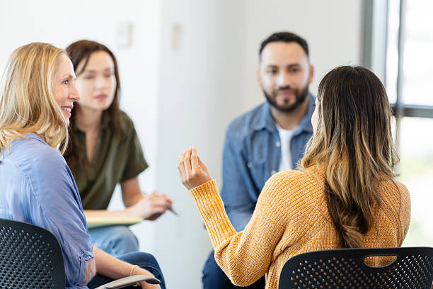 istock Group therapy session: Diverse adults discussing mental health 2230981472