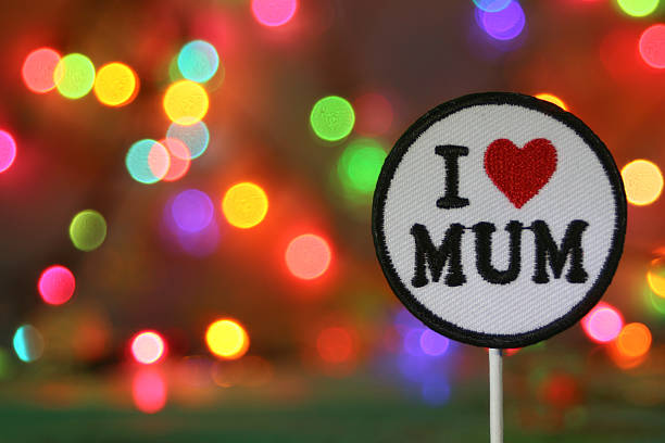 istock Handmade patch reading “I Love Mum” with colorful fireworks bokeh background, perfect for celebration designs with copy space. 2230982095