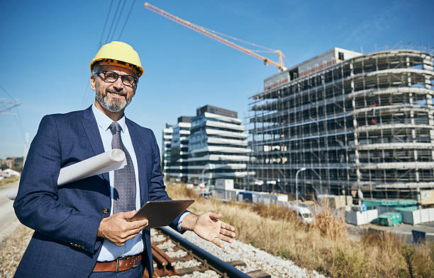 istock senior businessman architect helmet construction site building architecture tablet computer protective workwear blueprint plan 2230985220