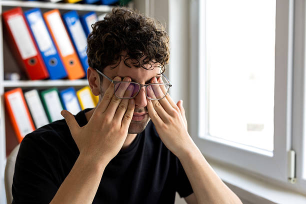 Tired man with glasses at office
