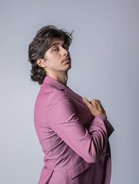 istock Young man wearing a pink suit. Vertical photo 2230987148