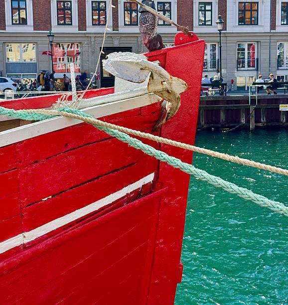 Nyhavn ia a 17th-century waterfront, canal and entertainment district in Copenhagen, Denmark.The colorful houses of Nyhavn are one of the most iconic sports  with restraints along the canal.