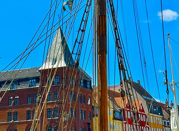 Nyhavn ia a 17th-century waterfront, canal and entertainment district in Copenhagen, Denmark.The colorful houses of Nyhavn are one of the most iconic sports  with restraints along the canal.