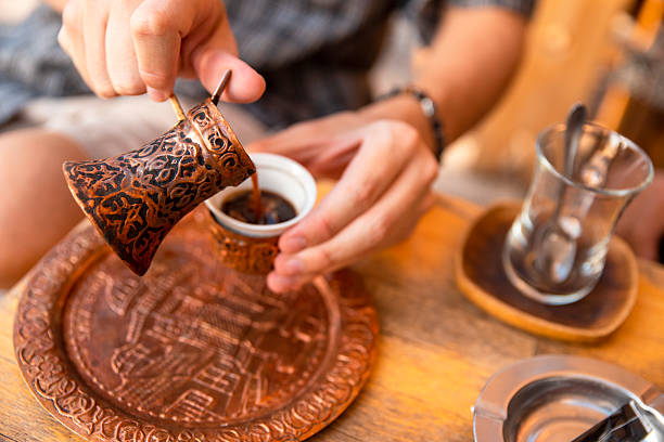 Man enjoys in Turkish coffee in sidewalk cafe
