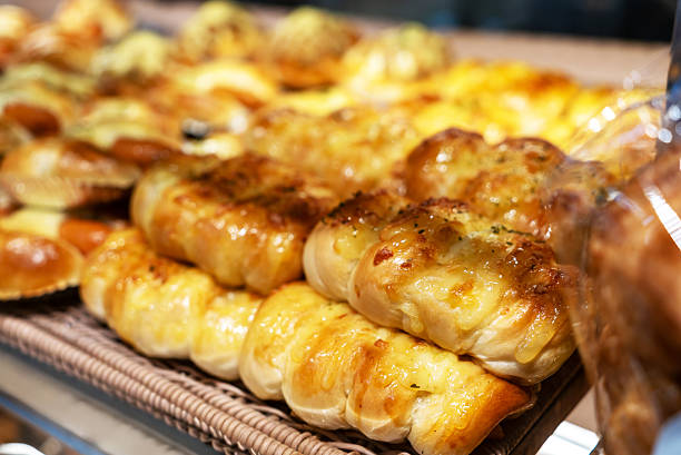A tempting assortment of freshly baked breads and pastries displayed invitingly. The golden textures and aromas create a warm and inviting atmosphere.