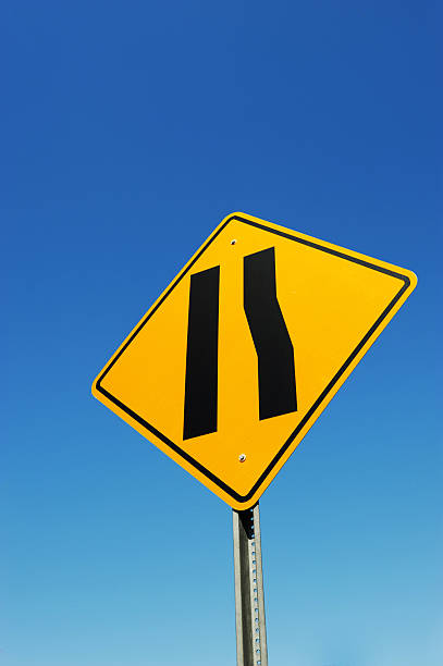 istock merge traffic sign against blue sky background 2230996653
