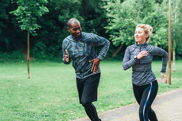 istock Cardio training outdoors. Happy athletic couple having fun while running together in nature. 2230996819